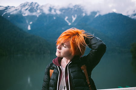 orange hair woman wearing black bubble jacket