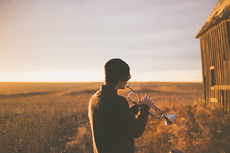 man playing trumpet during daytime