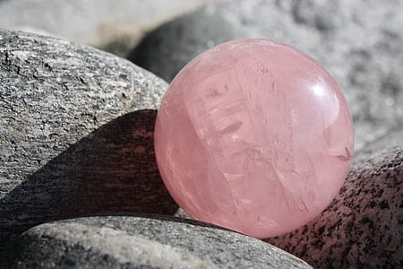 pink ball on gray rocks
