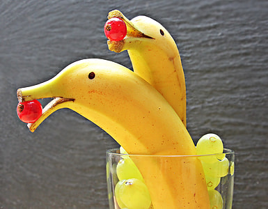 two banana fruits with cherries