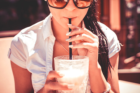 A Girl Drinking Milkshake Drink in Caffe