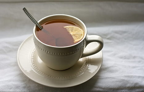 tea with lemon on white ceramic mug