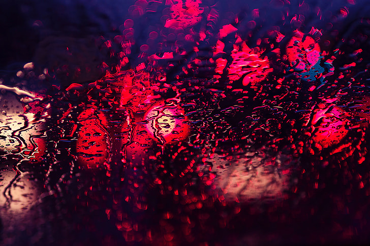 Abstract shot of rain and lights through glass texture window