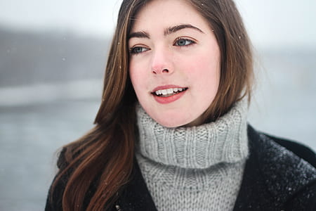 woman in grey turtleneck sweater in snow