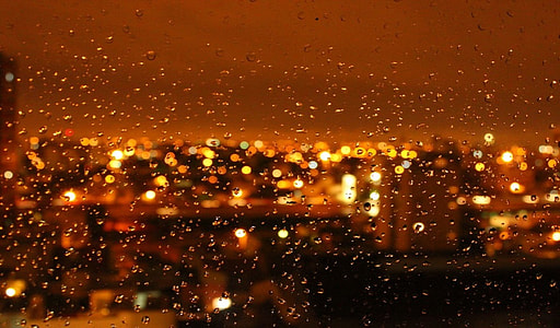 water droplets on clear glass window during night time
