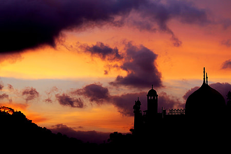 mosque near mountain during golden hour silhouette landscape photography