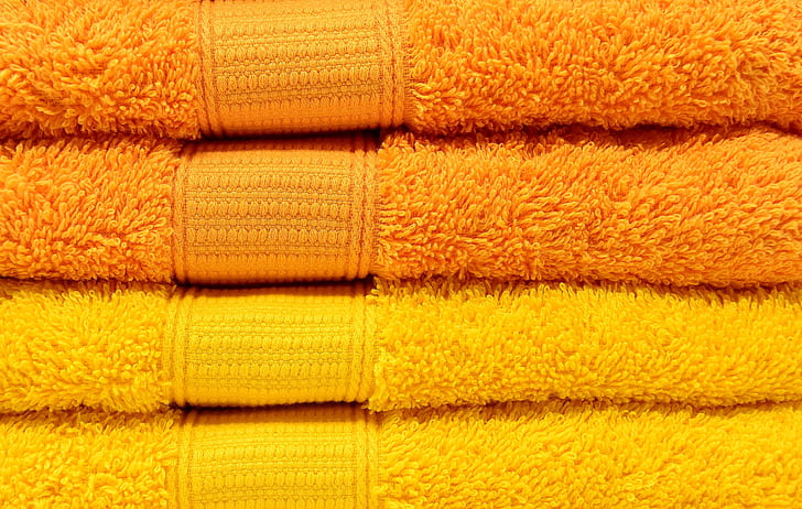 closeup photo of two yellow and two orange towels