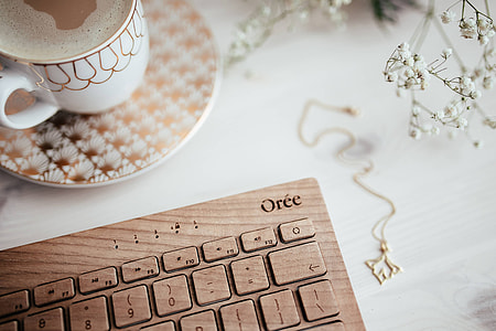 Wooden keyboard and cup of coffee