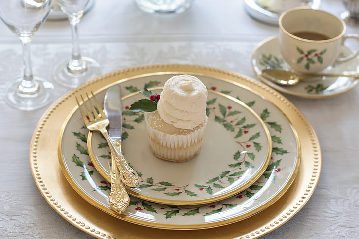 cupcake with three round ceramic plates and dinner knife and fork