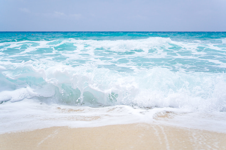 Blue ocean waves on a sandy beach