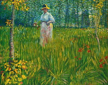 woman wearing hat standing and surrounded by grass painting