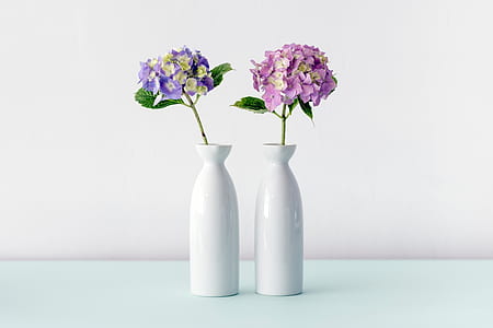 two milk glass vase with flowers