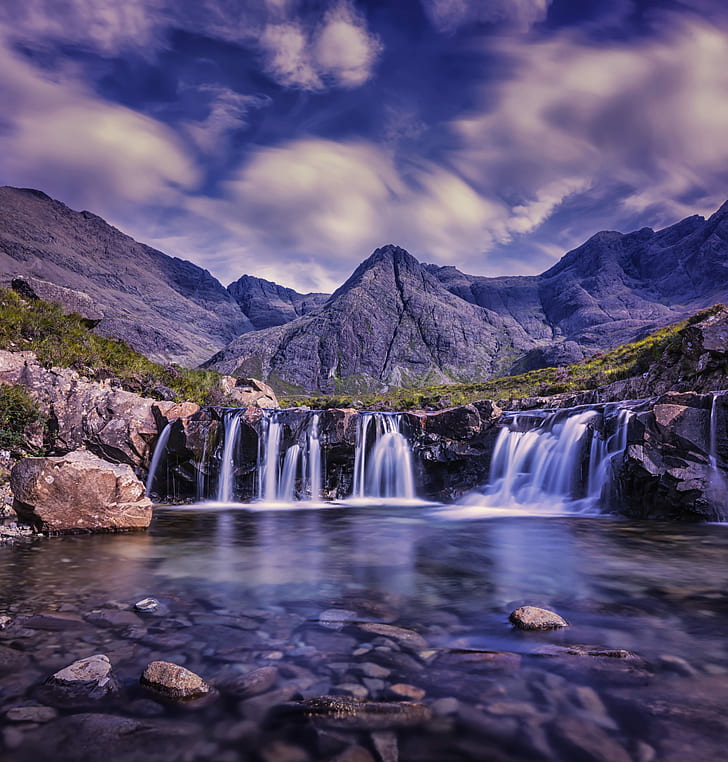 photography of waterfalls near mountains
