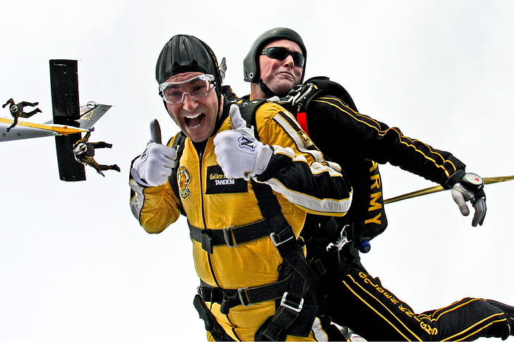 two men wearing black and yellow safety suits