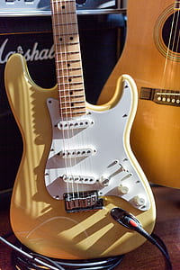 yellow and white electric guitar