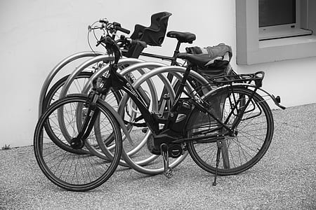 Black and Grey Bicycle Park Beside Wall