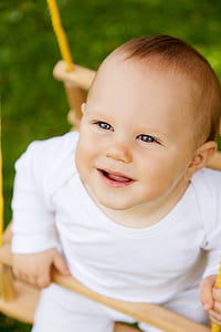 toddler in white long-sleeved shirt