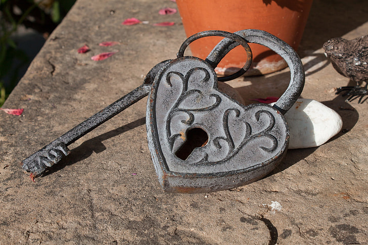 gray heart padlock with skeleton key