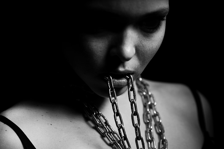 grayscale photography of woman eating chain