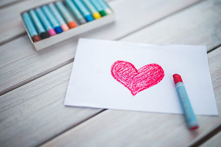 red heart drawing and red crayon