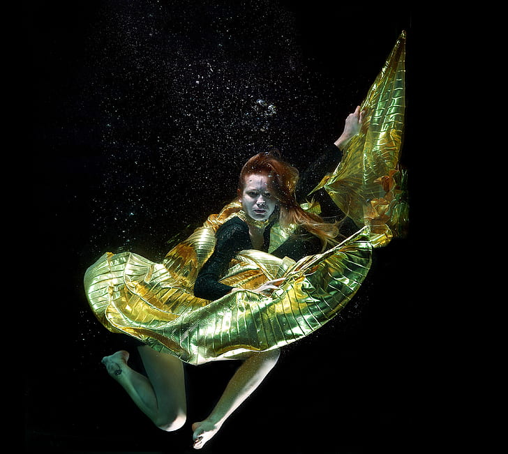 woman in yellow and black dress underwater
