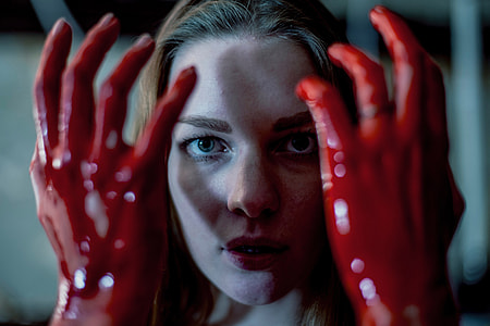 Woman with hands covered in blood