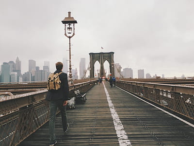 man walking on bridge during daytime