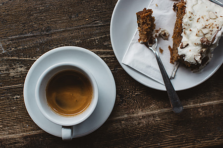 Espresso with carrot cake at a wooden table