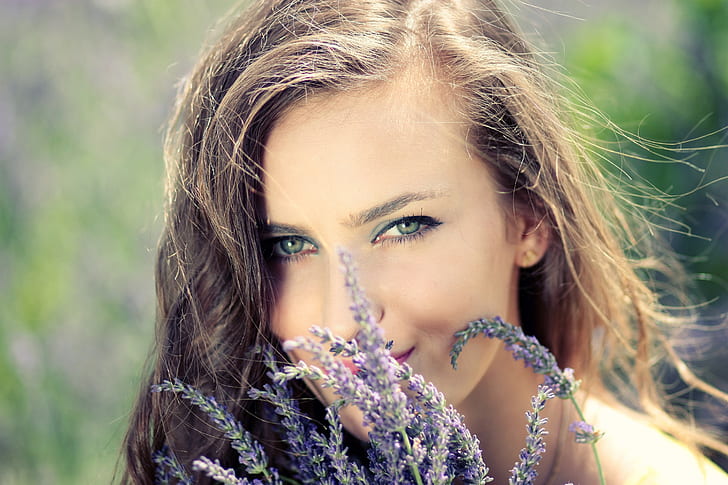 purple lavender infront of woman face