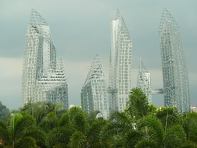 silver buildings surrounded by green trees during daytime