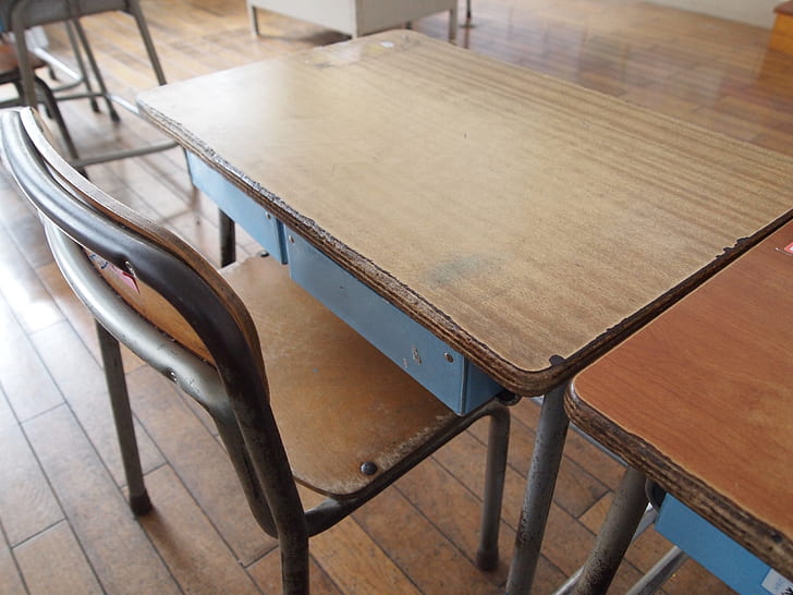rectangular brown wooden table beside armless chair