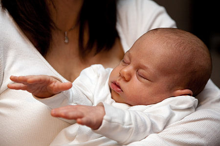 baby wearing white long-sleeved shirt