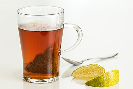 still life photography of clear glass mug filled with brown liquid