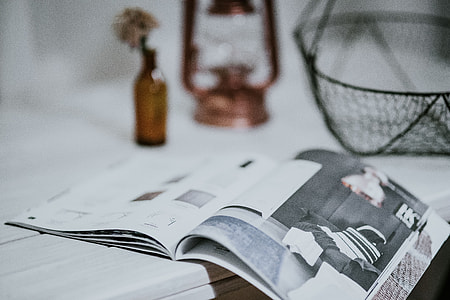 Magazine with a paraffin lamp on a white table