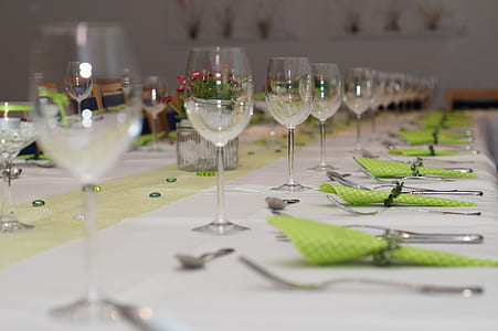 selective focus photography of wine glasses and forks with table napkins