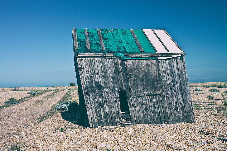Shot of an old abandoned shack that has started to subside. Image captured in Dungeness, Kent, England