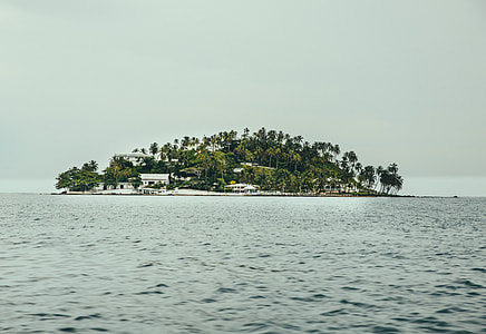 landscape photography of calm body of water and island