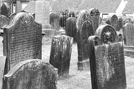 grayscale photo of assorted-shape tombstones