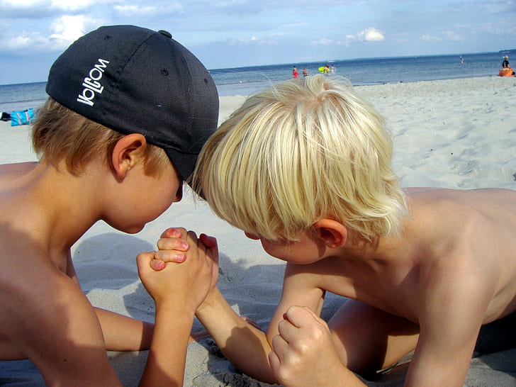 two boys playing at the beach