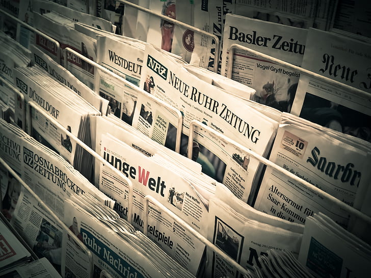 pile of newspapers on rack