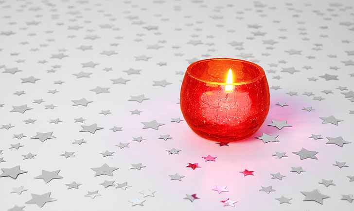 white candle with red candle holder