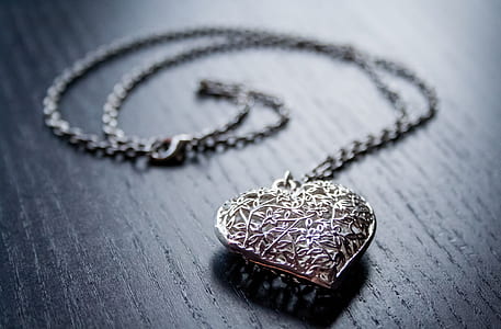 silver-colored necklace with heart pendant