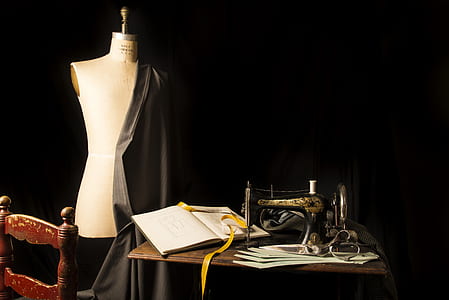brown sewing machine beside mannequin