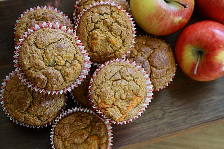 brown muffin beside red apple fruit