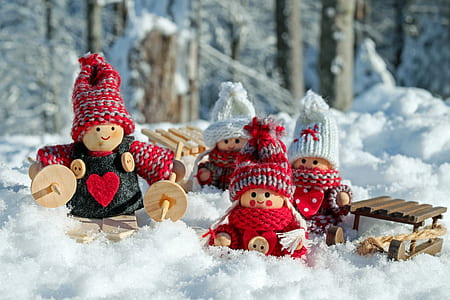 wooden dolls on snow-covered ground