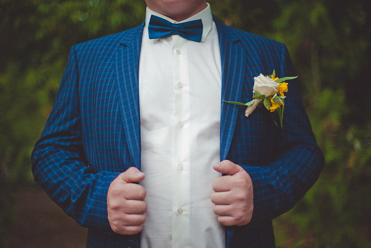 Wedding groom in suit and bow tie