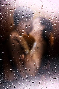 couple kissing behind glass
