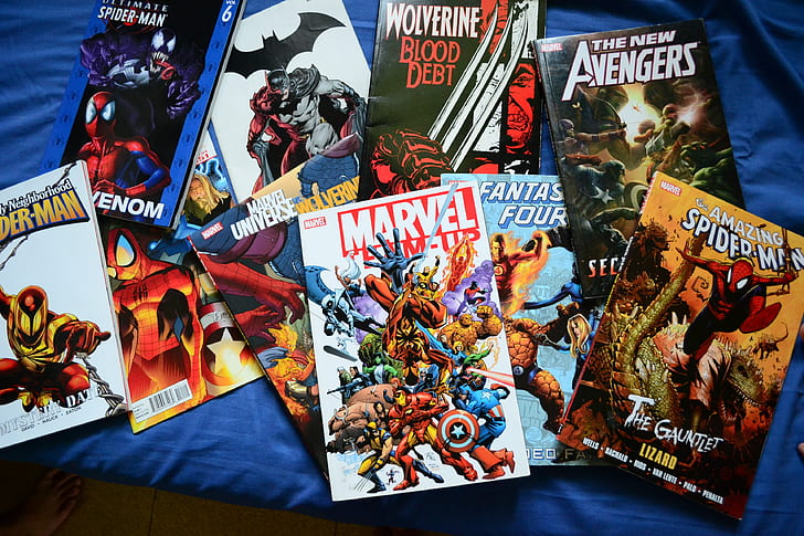 assorted comic book lot on blue textile