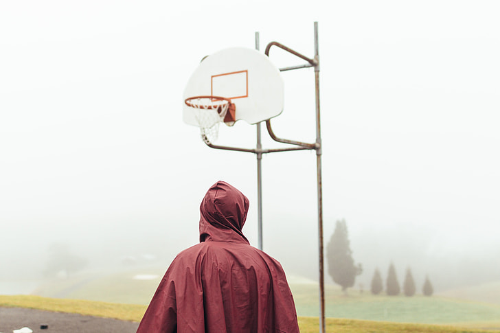 man standing in front of basketball hoop