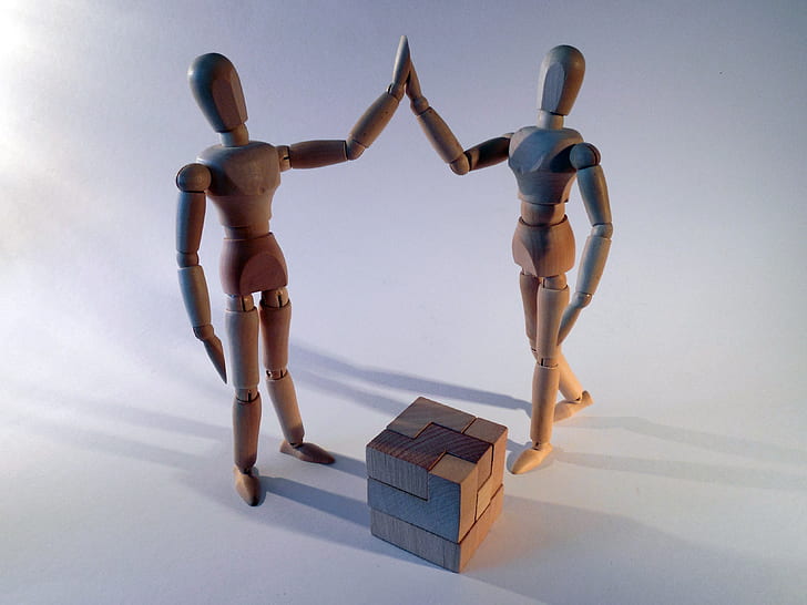 two brown wooden figure